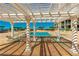 Serene pool area featuring a trellis, lounge chairs, and landscaping at 1390 Gulf Blvd # Ph-5, Clearwater, FL 33767