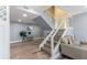 Living area with staircase featuring glass railing, light-colored floors, and modern decor at 1390 Gulf Blvd # Ph-5, Clearwater, FL 33767