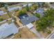 An aerial view of a home with pool, mature trees and landscaping nestled among neighboring properties at 1450 Palmetto St, Clearwater, FL 33755