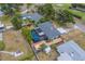 An overhead view reveals a home with a pool, green space, and a detached carport in a suburban setting at 1450 Palmetto St, Clearwater, FL 33755