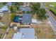 High-angle shot of a home with a screened-in pool, complemented by mature landscaping and neighborhood charm at 1450 Palmetto St, Clearwater, FL 33755