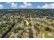 High aerial view pointing towards charming home with lush greenery near golf course and street at 1450 Palmetto St, Clearwater, FL 33755