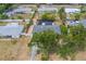 Aerial view showcasing a home with a screened-in pool, privacy fence, and mature trees at 1450 Palmetto St, Clearwater, FL 33755