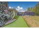 A lush backyard features a putting green and a screened-in pool area, perfect for outdoor entertainment at 1450 Palmetto St, Clearwater, FL 33755