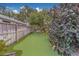 Charming backyard putting green with artificial turf, surrounded by mature landscaping at 1450 Palmetto St, Clearwater, FL 33755