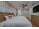 Spacious bedroom features wood floors, a ceiling fan, and a comfortable bed with orange accent pillows at 1450 Palmetto St, Clearwater, FL 33755