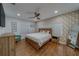 Light and airy bedroom with wood floors, a ceiling fan, and a wooden bed and matching furniture at 1450 Palmetto St, Clearwater, FL 33755