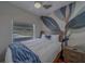 Cozy bedroom with a decorative blue and gray accent wall, wood floors, and a comfortable queen bed at 1450 Palmetto St, Clearwater, FL 33755