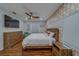 Light and airy bedroom with wood floors, a ceiling fan, and a wooden bed and matching furniture at 1450 Palmetto St, Clearwater, FL 33755