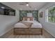 Bright bedroom with vibrant tropical wallpaper accent wall and light wood floors at 1450 Palmetto St, Clearwater, FL 33755