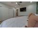 Spacious bedroom with a tropical wallpaper accent wall and ceiling fan at 1450 Palmetto St, Clearwater, FL 33755