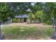 Charming single-story home with a well-manicured lawn and mature trees providing ample shade at 1450 Palmetto St, Clearwater, FL 33755