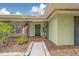 Inviting front porch with decorative ironwork, American flag, and a neatly landscaped walkway at 1450 Palmetto St, Clearwater, FL 33755
