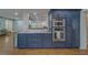 Updated kitchen with stainless appliances, granite countertops, and blue cabinetry at 1450 Palmetto St, Clearwater, FL 33755