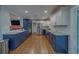 Updated kitchen featuring granite countertops, stainless steel appliances, and modern white and blue cabinets at 1450 Palmetto St, Clearwater, FL 33755