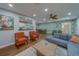 Inviting living room with tropical wallpaper, comfortable seating, and view into the updated kitchen at 1450 Palmetto St, Clearwater, FL 33755