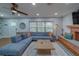 Comfortable living room with a large sectional sofa, modern fireplace, and ample natural light at 1450 Palmetto St, Clearwater, FL 33755