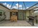 Outdoor entertaining with a bar, stools and a grill in the screened in patio area at 1450 Palmetto St, Clearwater, FL 33755