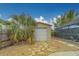 Detached shed with a screened-in pool in the background offers both convenience and leisure at 1450 Palmetto St, Clearwater, FL 33755