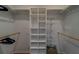 Walk-in closet with built-in storage shelves and ample hanging space for organizing clothes and accessories at 1450 Palmetto St, Clearwater, FL 33755