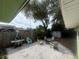 Tranquil backyard with gravel, stone pavers, a fire pit, comfortable seating, and mature trees at 1504 Orange St, Clearwater, FL 33756