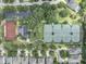 Aerial view showcasing tennis courts, community buildings, parking, and surrounding homes in a lush, green neighborhood at 15422 Starling Crossing Dr, Lithia, FL 33547