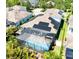 Aerial view of a home featuring a screened-in pool area and solar panels on the roof at 15422 Starling Crossing Dr, Lithia, FL 33547