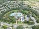 Stunning aerial view of a community with a large resort style pool, clubhouse, and lush landscaping at 15422 Starling Crossing Dr, Lithia, FL 33547