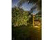 Backyard featuring a gazebo, lush trees, and outdoor illumination at 15422 Starling Crossing Dr, Lithia, FL 33547