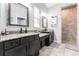 Well-appointed bathroom with dual sinks, granite countertops, and a tiled walk-in shower at 15422 Starling Crossing Dr, Lithia, FL 33547