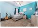 Bedroom featuring blue walls, carpeted floors, and guitars in the corner at 15422 Starling Crossing Dr, Lithia, FL 33547