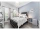 Bedroom featuring a queen size bed, hardwood floors and two windows at 15422 Starling Crossing Dr, Lithia, FL 33547