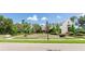 Beautifully landscaped entrance to the Starling Club with manicured lawns and flowerbeds at 15422 Starling Crossing Dr, Lithia, FL 33547