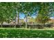A view of the back of the clubhouse through some trees and landscaping at 15422 Starling Crossing Dr, Lithia, FL 33547