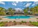 Large community pool with palm trees, lounge chairs, and a covered pavilion at 15422 Starling Crossing Dr, Lithia, FL 33547