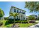 Beautiful two-story home with a manicured lawn, lush landscaping, and a charming front balcony at 15422 Starling Crossing Dr, Lithia, FL 33547