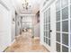 Elegant foyer showcasing tiled floors, decorative lighting, and a view into the living spaces at 15422 Starling Crossing Dr, Lithia, FL 33547