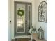 Close-up of the front door featuring decorative glass, a welcoming wreath, and stylish accents at 15422 Starling Crossing Dr, Lithia, FL 33547