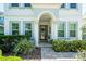 Charming front entrance featuring a decorative door, arched entryway, and meticulously maintained landscaping at 15422 Starling Crossing Dr, Lithia, FL 33547
