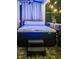 Nighttime view of a covered hot tub with steps and string lights for ambiance at 15422 Starling Crossing Dr, Lithia, FL 33547