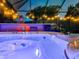 Illuminated hot tub featuring colorful 'welcome' sign, mood lighting, and lush greenery at 15422 Starling Crossing Dr, Lithia, FL 33547