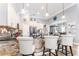 Kitchen island with granite countertops, white cabinets, and bar stool seating at 15422 Starling Crossing Dr, Lithia, FL 33547