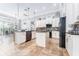 Spacious kitchen featuring white cabinets, dual islands, and modern stainless steel appliances at 15422 Starling Crossing Dr, Lithia, FL 33547