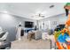 Open living room featuring a sectional couch, entertainment area, and arcade game at 15422 Starling Crossing Dr, Lithia, FL 33547