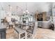 Open concept living space featuring kitchen, dining area, and living room with stone fireplace accent wall at 15422 Starling Crossing Dr, Lithia, FL 33547