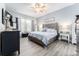 Serene main bedroom showcasing a plush bed, decorative wall, and hardwood flooring at 15422 Starling Crossing Dr, Lithia, FL 33547