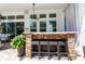 Outdoor covered stone bar with seating and ceiling fan is ideal for entertaining friends and Gathering at 15422 Starling Crossing Dr, Lithia, FL 33547