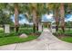 Green Cross Park features a gazebo, lush green lawn, palm trees, and manicured landscaping in a fenced community space at 15422 Starling Crossing Dr, Lithia, FL 33547