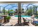 Inviting screened lanai with outdoor seating and a beautiful in-ground pool at 15422 Starling Crossing Dr, Lithia, FL 33547