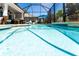 Screened-in pool with an umbrella and various outdoor chairs is perfect for the Florida lifestyle at 15422 Starling Crossing Dr, Lithia, FL 33547